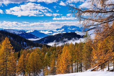 Scenic view of snowcapped mountains against sky during autumn