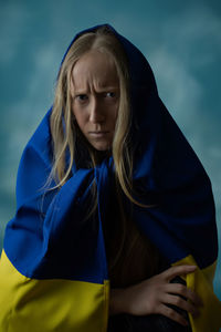 Upset woman with ukrainian flag