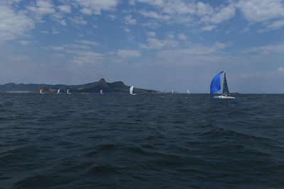 Sailboat in sea against sky