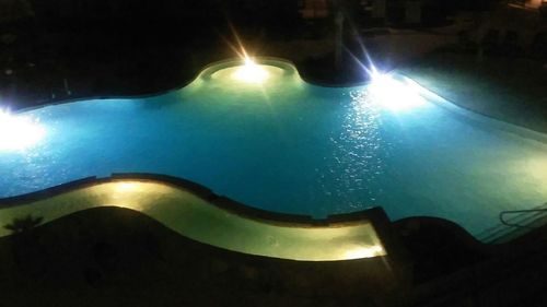 Low angle view of illuminated blue sky at night