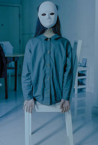 Close-up of woman standing against wall