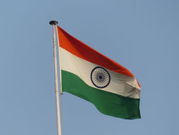 Low angle view of indian flag against clear blue sky