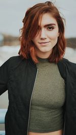 Portrait of smiling young woman standing outdoors