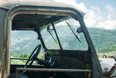 Abandoned car against sky