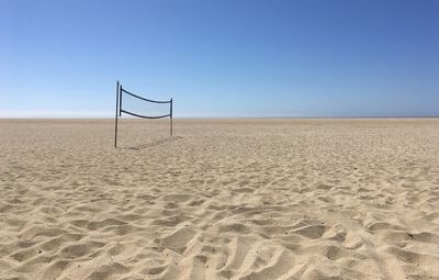 Scenic view of desert against clear blue sky