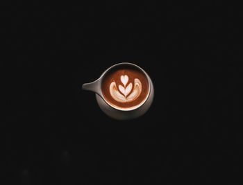 Close-up of coffee cup against black background