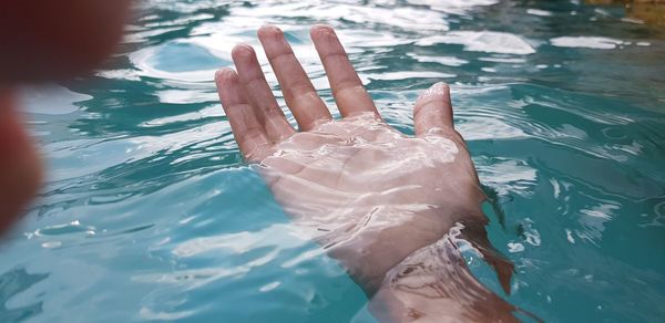 Midsection of woman swimming in pool