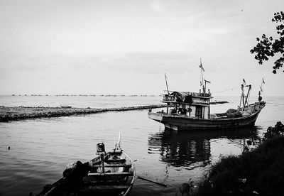 Ship moored on sea against sky