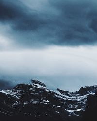 Scenic view of mountains against cloudy sky