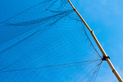 Low angle view of sailboat against clear blue sky
