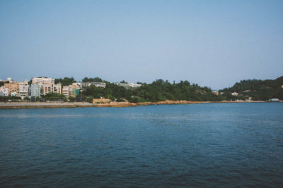 Calm sea with buildings in background