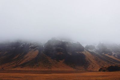 Scenic view of landscape against cloudy sky