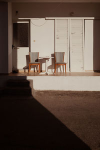 Empty chairs and table in building