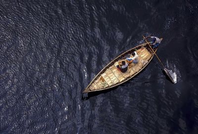 High angle view of men sailing boat on buriganga river