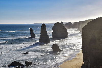 Rocks on beach against sky