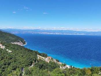 High angle view of sea against blue sky