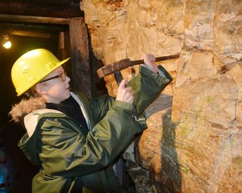 Boy hammering wall