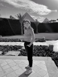 Portrait of woman standing outdoors in front of pyramids