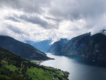 Scenic view of river amidst mountains against sky