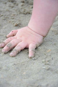 Low section of person on sand