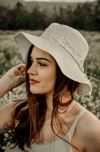 Close-up of young woman wearing hat