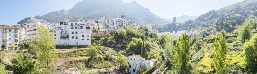 Panoramic view of trees and mountains against sky