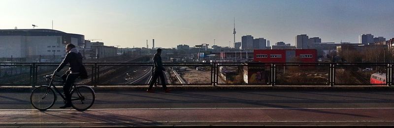 Man with bicycle parked in city