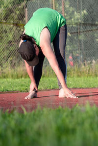Full length of man skateboarding on grass