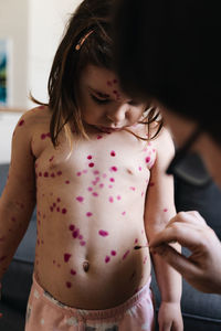 Midsection of mother and daughter at home