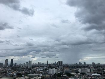 Aerial view of buildings in city against sky