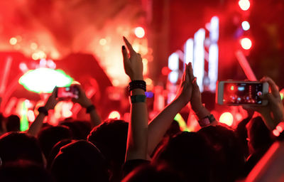 Rear view of people enjoying at music concert