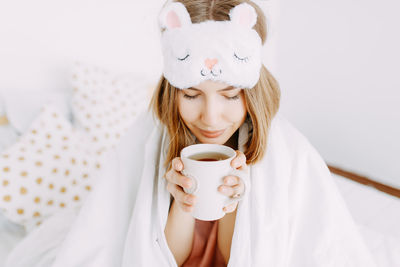 Young woman drinking coffee cup