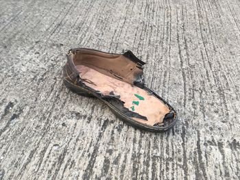 High angle view of abandoned shoes on wood