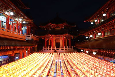 Illuminated temple building in city at night