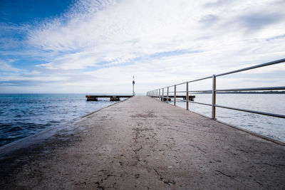 Pier over sea against sky