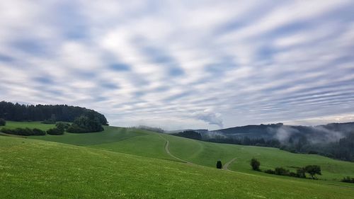 Scenic view of golf course against sky