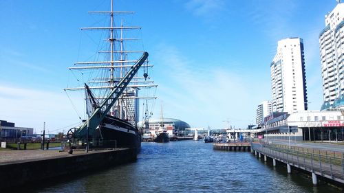 Bridge over river in city against clear sky