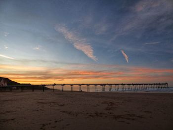 Scenic view of beach against sky during sunset