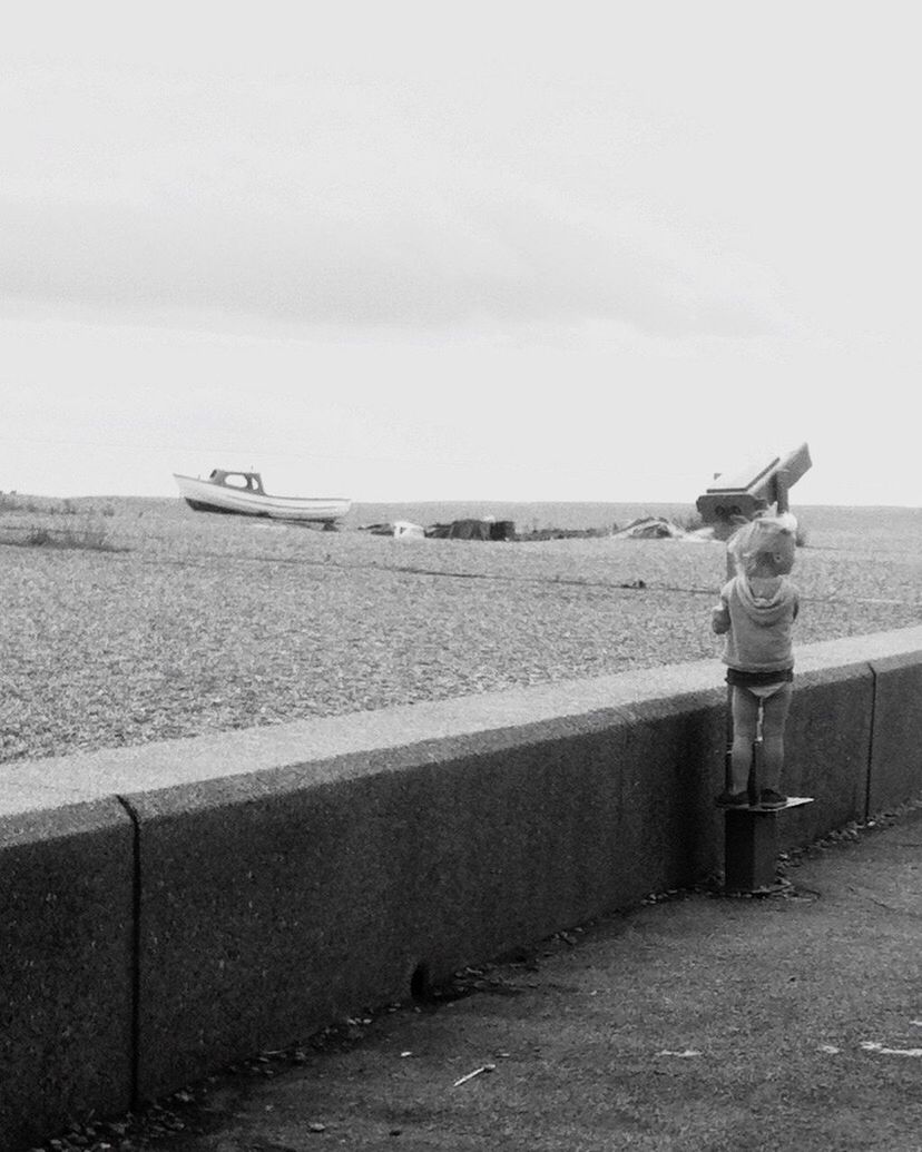 WOMAN STANDING BY WATER