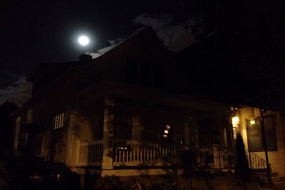 Low angle view of buildings against sky at night