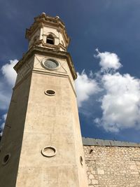 Low angle view of clock tower against sky