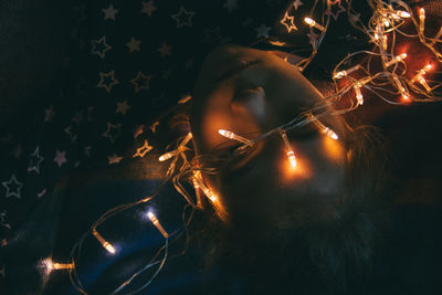Close-up of girl with illuminated lights