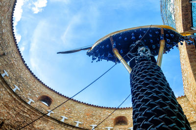 Low angle view of bird sculpture against sky