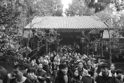 People walking out from traditional building