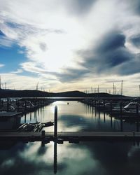 View of harbor against cloudy sky