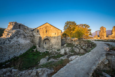 View of old building against blue sky, ujarma, kakheti, georgia