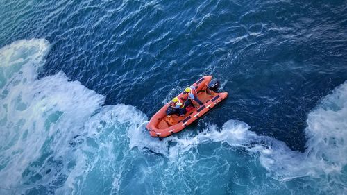 High angle view of people floating on sea