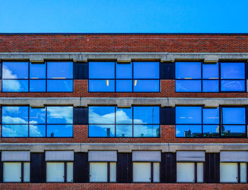 Low angle view of building against blue sky