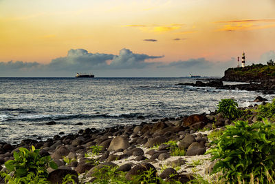 Sunset on the rocky beach of albion, mauritius.