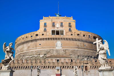 Low angle view of historical building against blue sky